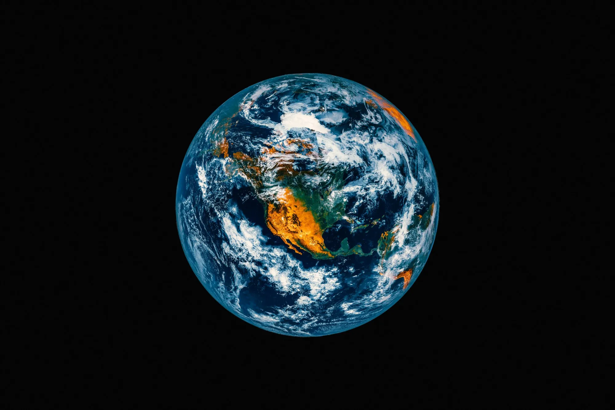 The Earth photographed from space against black, the Americas and the north Atlantic lit and half covered by cloud.